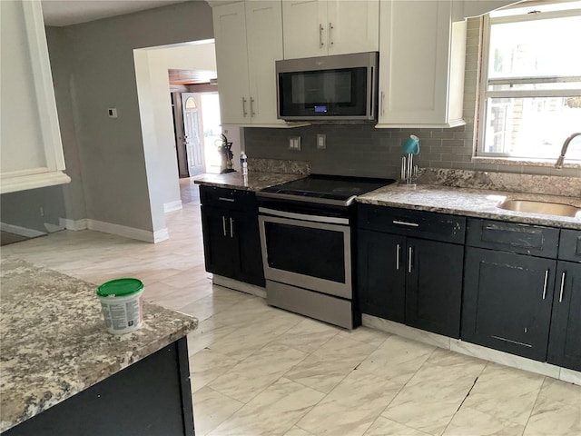 434 Diamond Acres Rd, Davenport, FL 33837 - kitchen with a sink, dark cabinets, a wealth of natural light, and stainless steel appliances