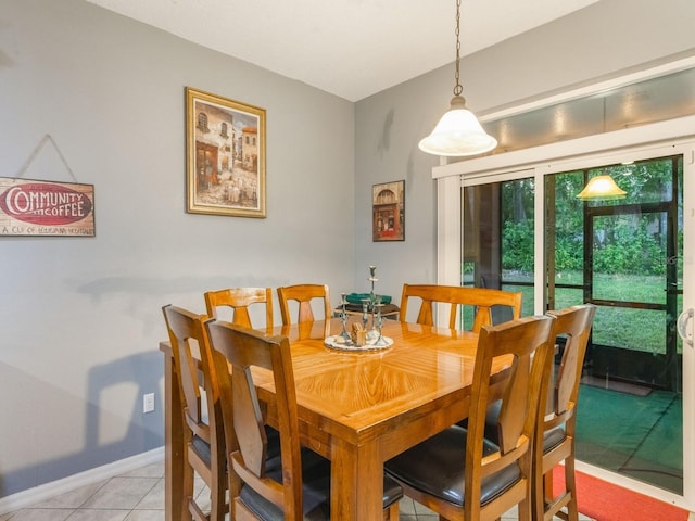 dining room with baseboards and light tile patterned flooring