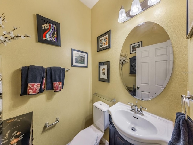 bathroom with toilet and vanity
