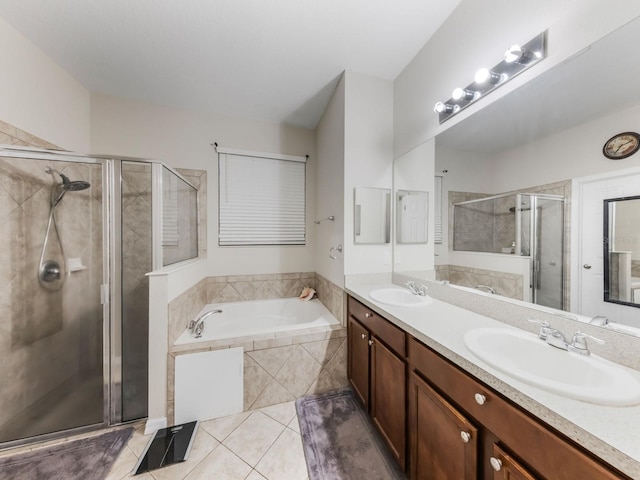 full bath featuring a stall shower, a bath, tile patterned floors, and a sink