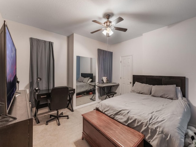 bedroom with a ceiling fan and light colored carpet