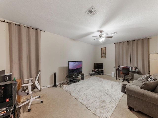carpeted living area with baseboards, a ceiling fan, and visible vents