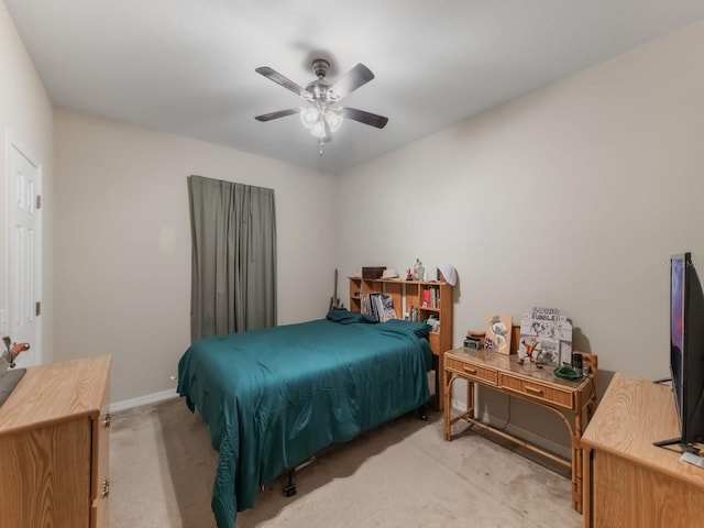bedroom with light colored carpet, baseboards, and a ceiling fan