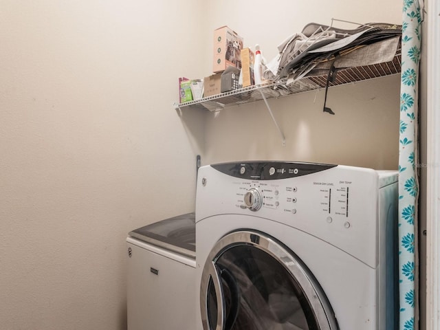 washroom featuring laundry area and washer and clothes dryer