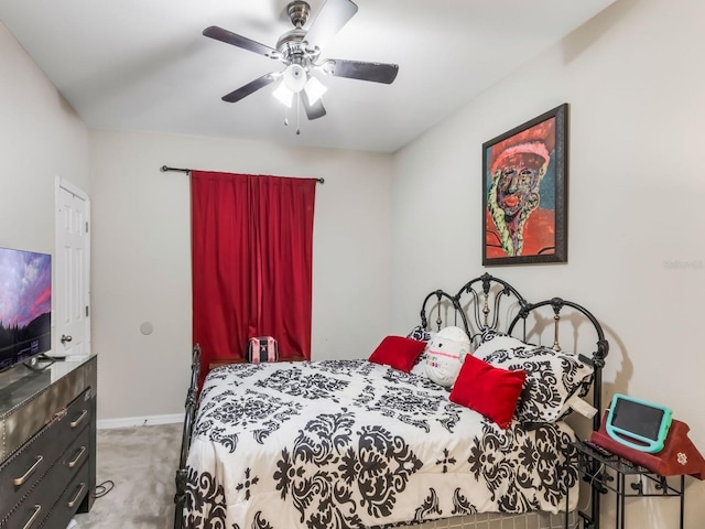 carpeted bedroom with baseboards and ceiling fan