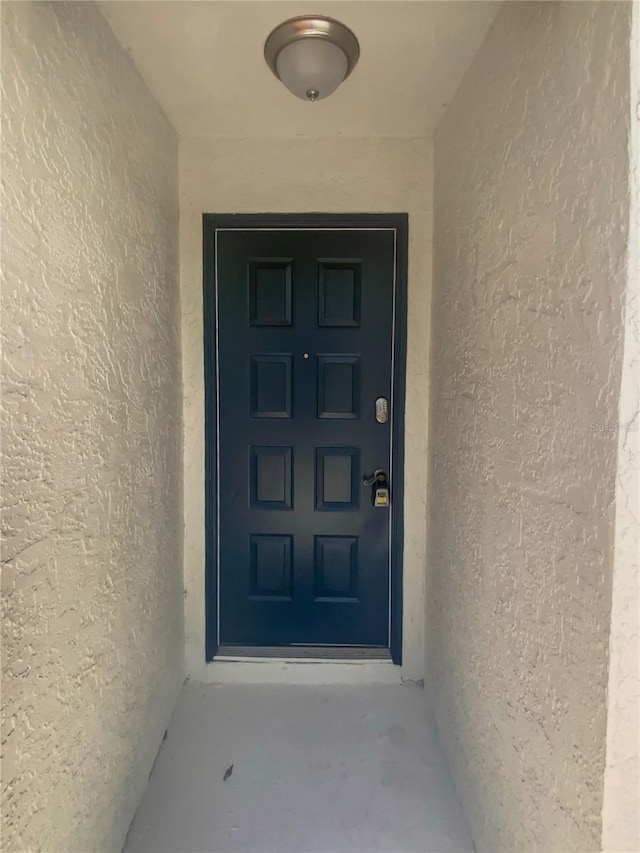 doorway to property with stucco siding