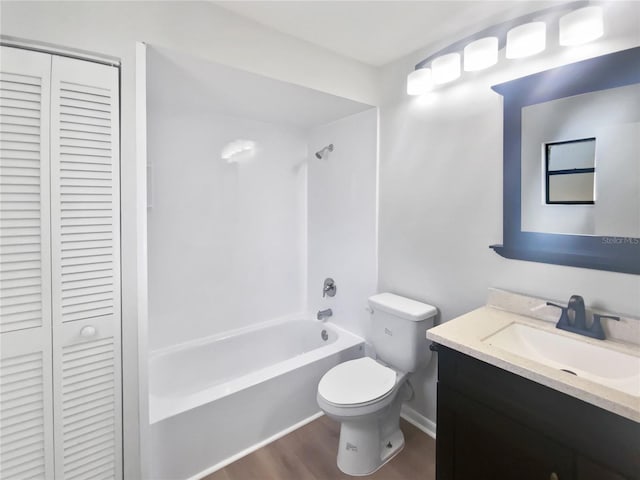 full bathroom featuring wood finished floors, a closet, vanity, toilet, and bathing tub / shower combination