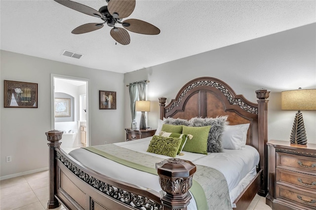 bedroom featuring a ceiling fan, connected bathroom, light tile patterned flooring, baseboards, and visible vents