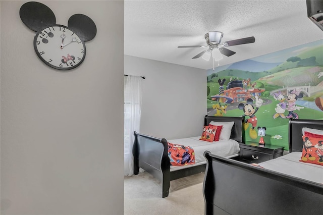 carpeted bedroom featuring a textured ceiling and ceiling fan