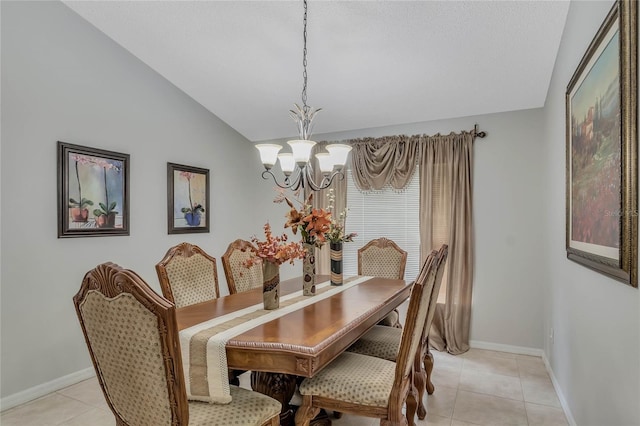 dining area with lofted ceiling, baseboards, a chandelier, and light tile patterned floors