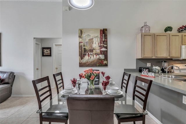 dining area with baseboards and light tile patterned flooring