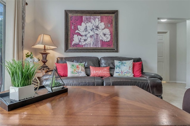tiled living room featuring baseboards