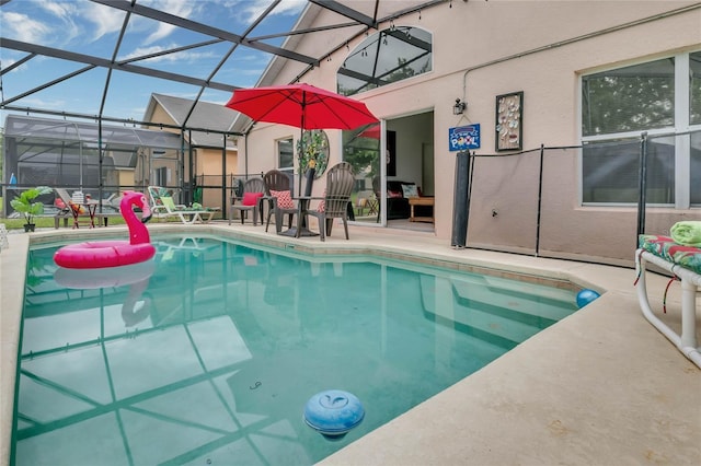 outdoor pool with glass enclosure and a patio