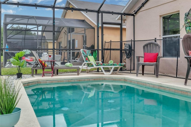 pool with glass enclosure and a patio