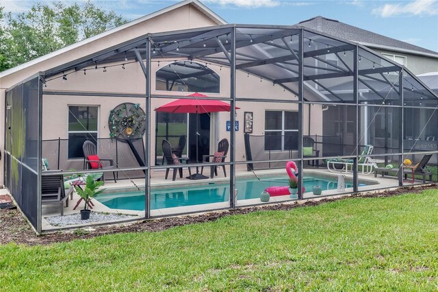 rear view of property with glass enclosure, an outdoor pool, a yard, a patio, and stucco siding
