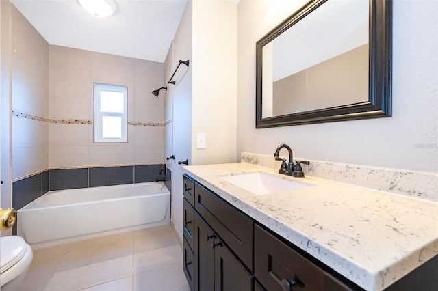 full bath with tile patterned floors, toilet, vanity, and washtub / shower combination