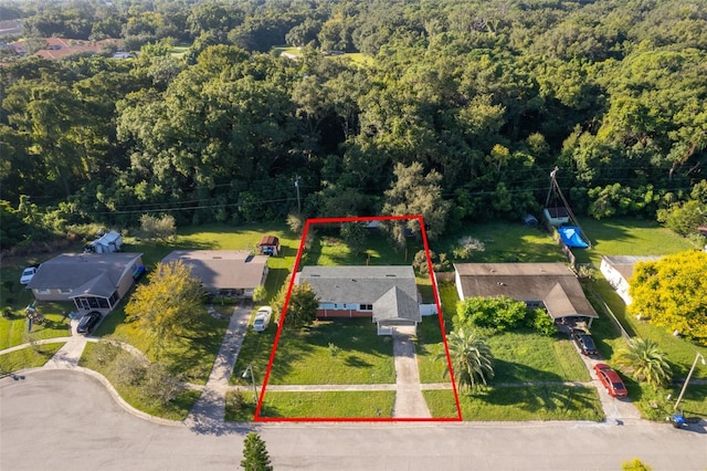 birds eye view of property featuring a wooded view