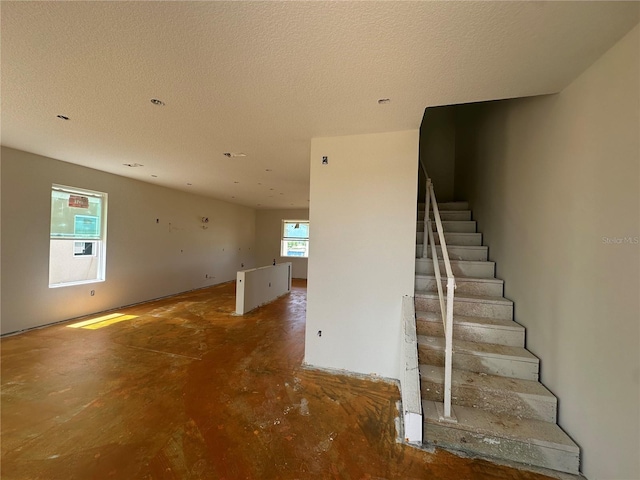 17347 Beachgrass Aly, Winter Garden, FL 34787 - stairway featuring concrete flooring and a textured ceiling