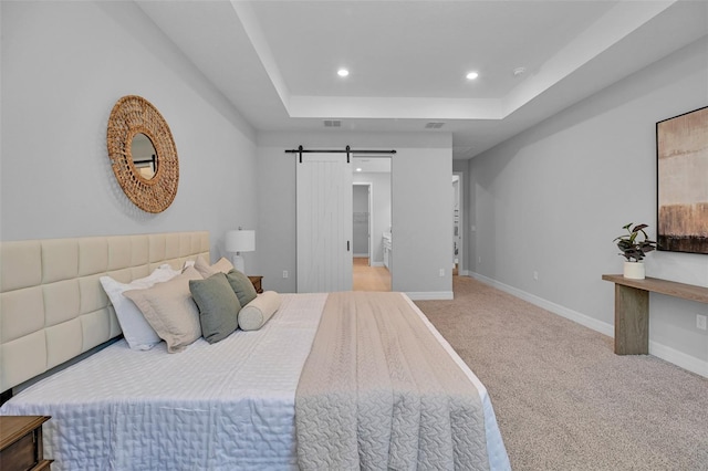 bedroom with baseboards, recessed lighting, carpet flooring, a barn door, and a tray ceiling