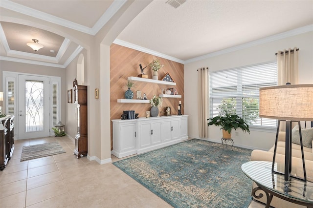 2530 Stargrass Cir, Clermont, FL 34715 - foyer with wooden walls, visible vents, arched walkways, crown molding, and baseboards