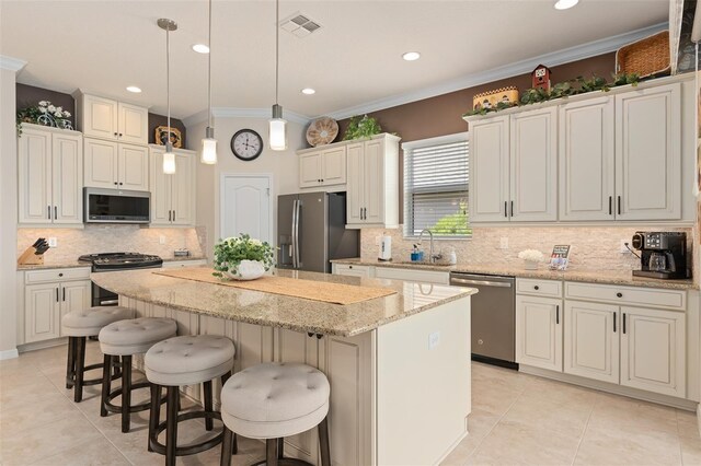 2530 Stargrass Cir, Clermont, FL 34715 - kitchen with light tile patterned flooring, visible vents, backsplash, a kitchen island, and appliances with stainless steel finishes