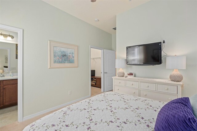2530 Stargrass Cir, Clermont, FL 34715 - bedroom with ensuite bathroom, baseboards, a spacious closet, and light colored carpet