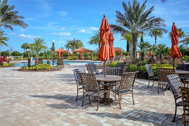 2530 Stargrass Cir, Clermont, FL 34715 - view of patio featuring a gazebo, outdoor dining area, and a community pool