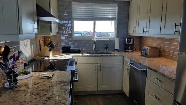kitchen featuring a sink, light stone counters, tasteful backsplash, and stainless steel appliances