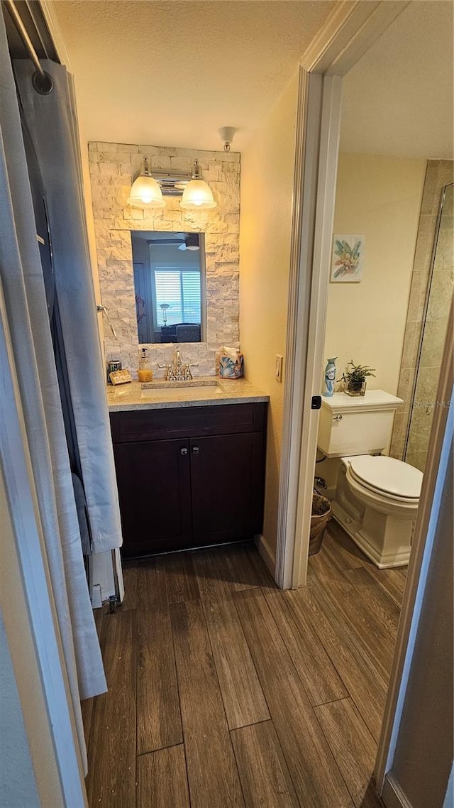 bathroom with vanity, toilet, and wood finished floors