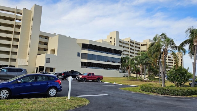 view of building exterior with uncovered parking