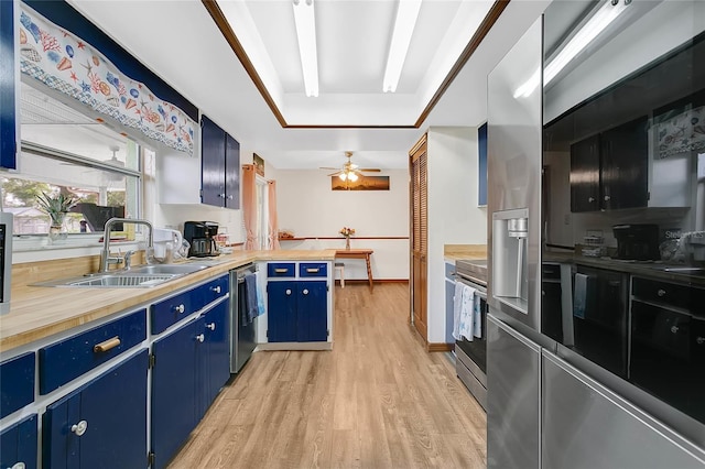 432 Taylorville St, Deltona, FL 32725 - kitchen featuring blue cabinets, stainless steel appliances, a sink, light wood-type flooring, and a raised ceiling