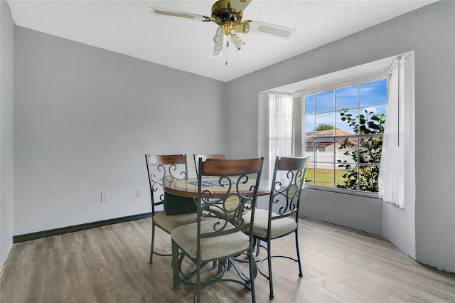 432 Taylorville St, Deltona, FL 32725 - dining room with light wood-type flooring, a textured ceiling, and a ceiling fan