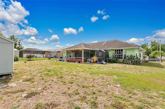 432 Taylorville St, Deltona, FL 32725 - back of property featuring a lawn and a sunroom