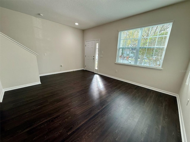 8271 Maritime Flag St Unit 125, Windermere, FL 34786 - unfurnished living room with recessed lighting, baseboards, a textured ceiling, and dark wood finished floors
