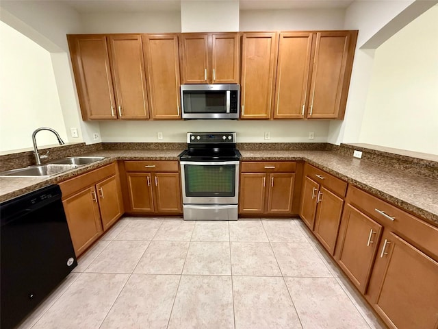 8271 Maritime Flag St Unit 125, Windermere, FL 34786 - kitchen featuring dark countertops, a peninsula, a sink, and appliances with stainless steel finishes