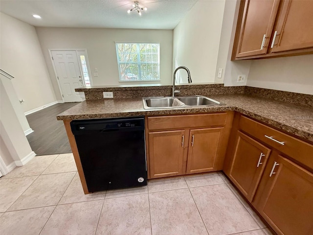 8271 Maritime Flag St Unit 125, Windermere, FL 34786 - kitchen with a peninsula, black dishwasher, dark countertops, brown cabinetry, and a sink