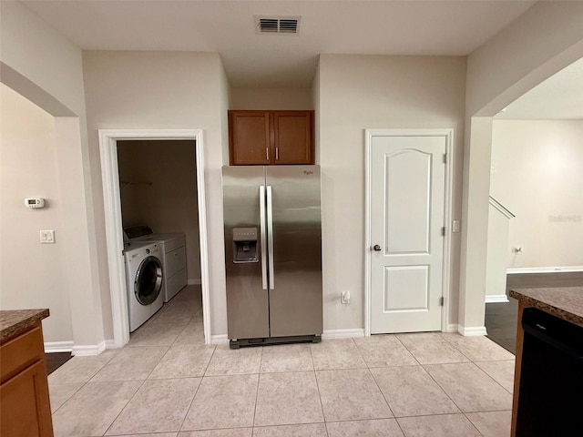 8271 Maritime Flag St Unit 125, Windermere, FL 34786 - kitchen with light tile patterned flooring, visible vents, stainless steel fridge with ice dispenser, and washing machine and dryer