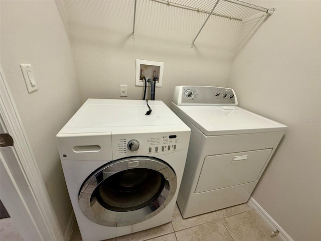 8271 Maritime Flag St Unit 125, Windermere, FL 34786 - washroom with separate washer and dryer, laundry area, baseboards, and light tile patterned flooring