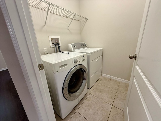 8271 Maritime Flag St Unit 125, Windermere, FL 34786 - laundry room with light tile patterned floors, washer and clothes dryer, laundry area, and baseboards