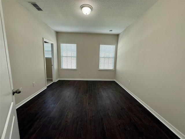 8271 Maritime Flag St Unit 125, Windermere, FL 34786 - empty room with dark wood-type flooring, a textured ceiling, baseboards, and visible vents