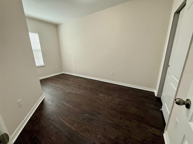8271 Maritime Flag St Unit 125, Windermere, FL 34786 - spare room featuring dark wood-type flooring and baseboards