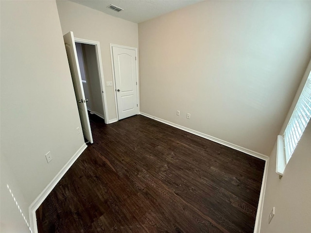 8271 Maritime Flag St Unit 125, Windermere, FL 34786 - unfurnished bedroom with visible vents, baseboards, and dark wood finished floors