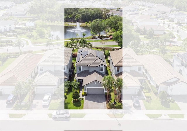 birds eye view of property with a residential view and a water view