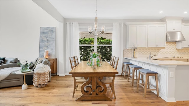 dining area featuring recessed lighting, baseboards, an inviting chandelier, and light wood-type flooring