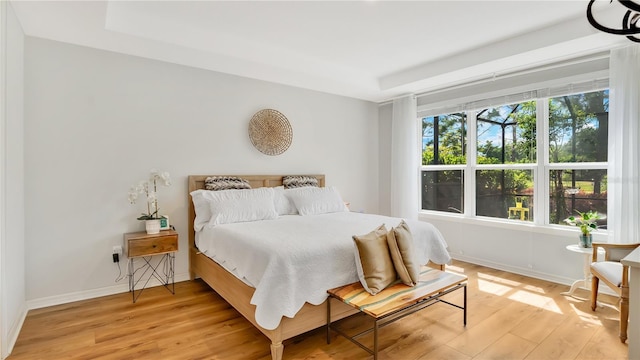 bedroom with baseboards and light wood finished floors
