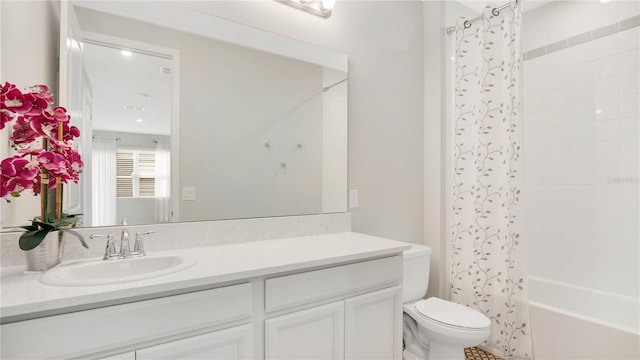 full bathroom with toilet, shower / tub combo with curtain, and vanity