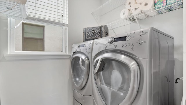 clothes washing area featuring laundry area and washer and dryer