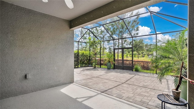 view of patio / terrace with a lanai and ceiling fan