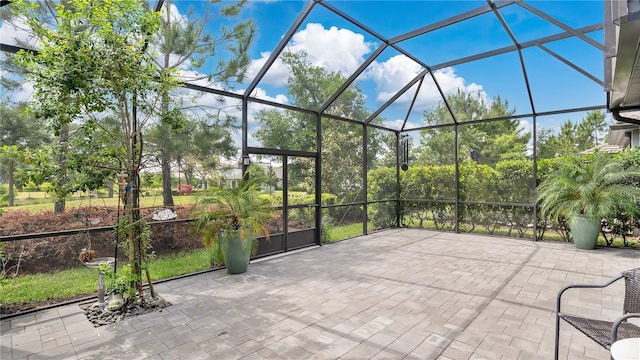 view of patio featuring a lanai
