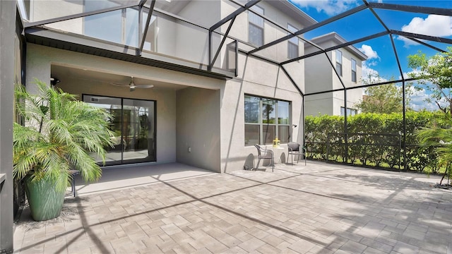 view of patio with a ceiling fan and a lanai